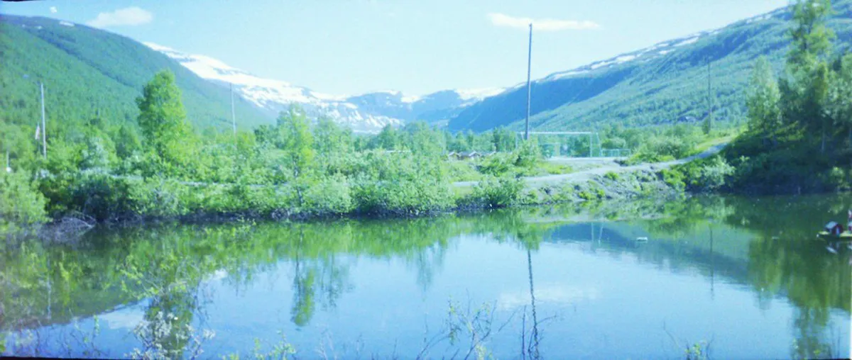 Glass igloo structure in Tromsø with clear glass roof panels and snow, designed for viewing aurora borealis