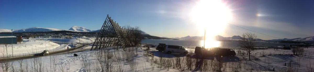 Modern Tromsø Airport terminal building with winter landscape and aircraft, Arctic Norway