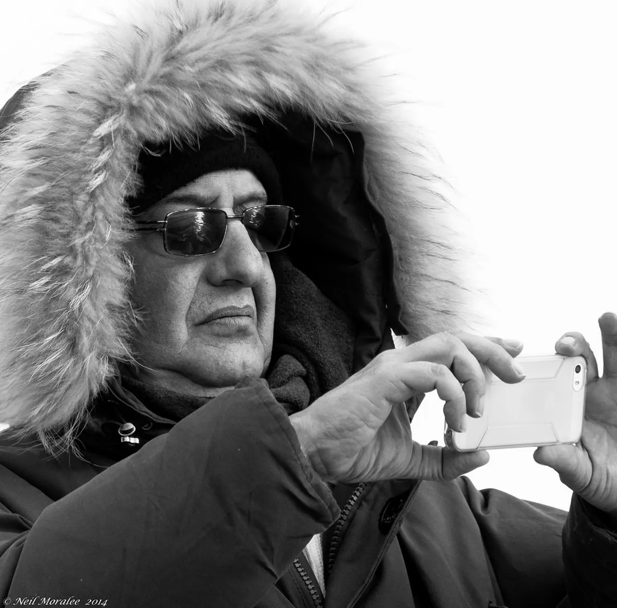 Professional camera lens and tripod equipment in cold Arctic conditions with frost coverage