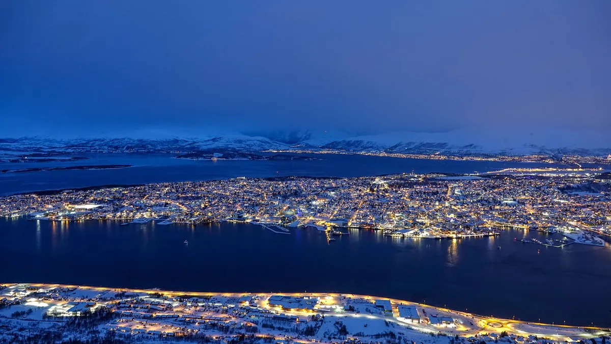 Scenic view of Tromsø city nestled in Arctic mountains and fjords, Norway
