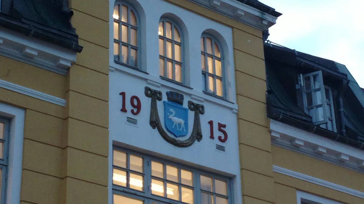 Outdoor winter cinema projection under Arctic night sky in Tromsø, Norway with bundled audience
