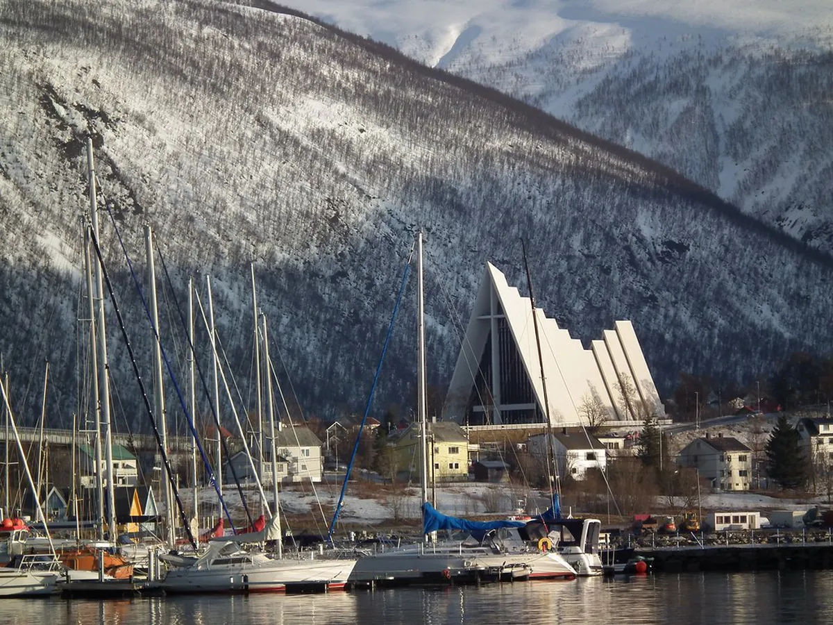 Specialty pour-over coffee with Arctic pastry in cozy Tromsø café during winter snow